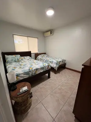 a room with two beds and a basket in it at Serena Suites L2 Playas del Coco in Coco