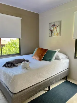 a bed with two pillows and a window in a room at Apartamento del sol #3 in Tilarán