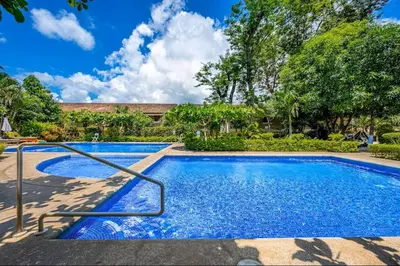 a swimming pool in a yard with trees at Sweet Dreams #49 Playa Ocotal in Coco