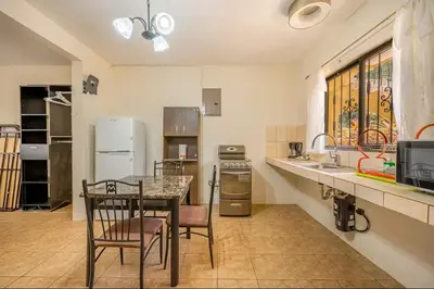 a kitchen with a table and chairs in a room at Sweet Dreams #49 Playa Ocotal in Coco