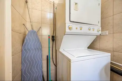a washer and dryer in a small kitchen with a washer at Sweet Dreams #49 Playa Ocotal in Coco