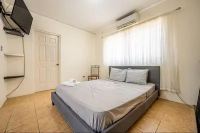 a bedroom with a bed and a television in it at Sweet Dreams #49 Playa Ocotal in Coco