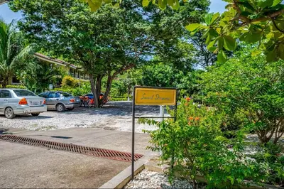 a yellow sign in front of a parking lot at Sweet Dreams #49 Playa Ocotal in Coco