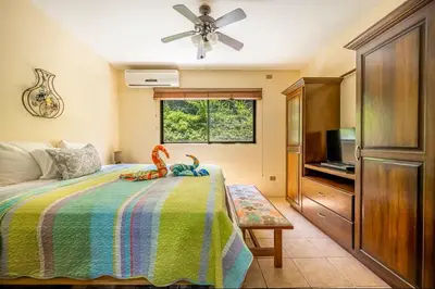 a bedroom with a bed and a ceiling fan at Sweet Dreams #5 Playa Ocotal in Coco