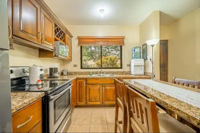 a kitchen with wooden cabinets and a counter top at Sweet Dreams #5 Playa Ocotal in Coco