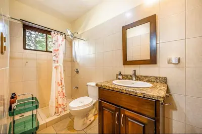 a bathroom with a sink and a toilet and a mirror at Sweet Dreams #5 Playa Ocotal in Coco