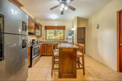 a kitchen with a refrigerator and a table with chairs at Sweet Dreams #5 Playa Ocotal in Coco