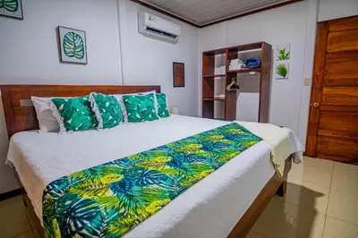 a bedroom with a large bed with a colorful comforter at Rustic Ranch in Fortuna