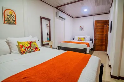 a bedroom with two beds with orange and white at Rustic Ranch in Fortuna