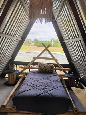 a bed in a room with a large window at A-frame cabin in Palma