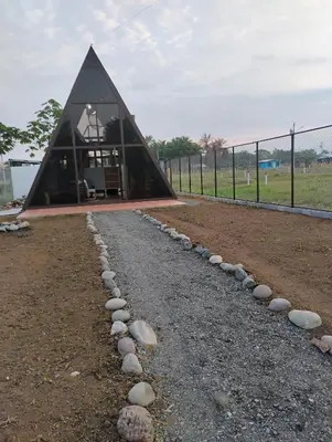 a building with a gravel path in front of it at A-frame cabin in Palma