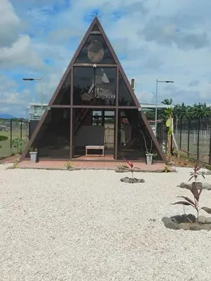 a building with a triangular roof on the beach at A-frame cabin in Palma