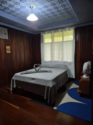 a bedroom with a bed in a room with a window at Villa Azul in Abundancia