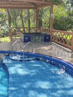 a large swimming pool with a gazebo at Villa Azul in Abundancia