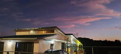 a house with a car parked in front of it at Monteverde Coati & Sloth Studios Apartaments Hotel in Monteverde Costa Rica