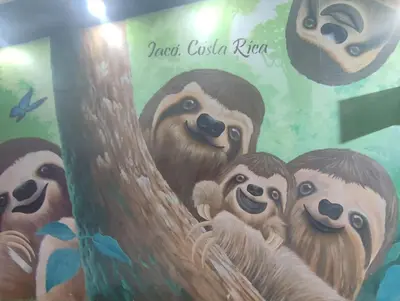 a mural of three sloths climbing a tree at Stylish 2 bed and 2 bath condo with mountain and pool view in Jacó in Jacó