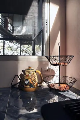 a tea pot and a basket on a counter at The Emerald Haven in Parrita