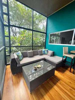 a living room with a couch and a table at The Emerald Haven in Parrita