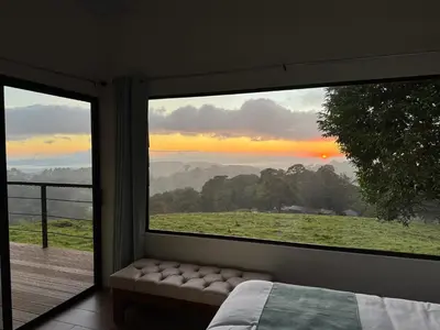 a room with a large window with a bed and a view at Apricus Costa Rica in Monteverde Costa Rica