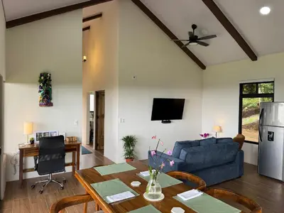 a living room with a blue couch and a table at Apricus Costa Rica in Monteverde Costa Rica