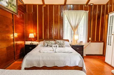 a bedroom with a bed with two towels on it at Monteverde Wildlife Paradise - Nature Lovers in San Luis