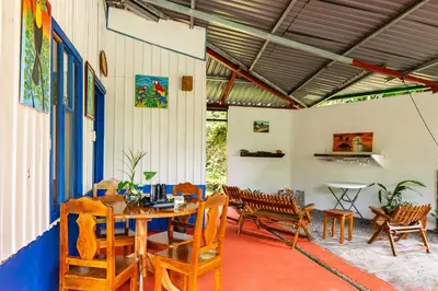 a patio with a table and chairs and a table at Monteverde Wildlife Paradise - Nature Lovers in San Luis