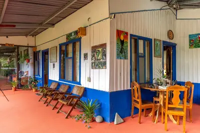 a group of chairs and a table in a building at Monteverde Wildlife Paradise - Nature Lovers in San Luis