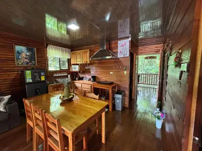 a kitchen with a wooden table and a dining room at Cabin in the wood in San Francisco