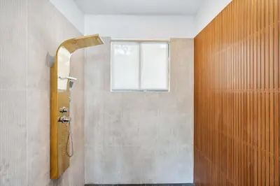 a bathroom with a shower with a window at Waterfall Pool, Kids' Paradise, Quiet Beaches in Playa Grande