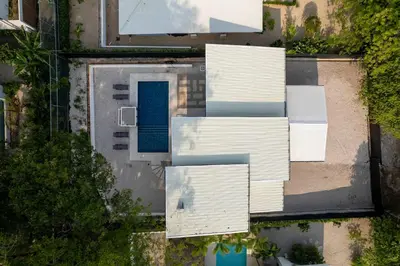 an overhead view of a white building with a blue door at Waterfall Pool, Kids' Paradise, Quiet Beaches in Playa Grande