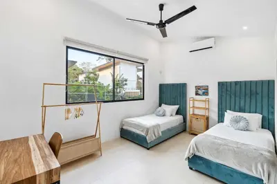 a bedroom with two beds and a window at Waterfall Pool, Kids' Paradise, Quiet Beaches in Playa Grande