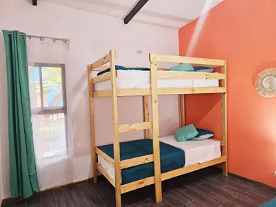 a bedroom with two bunk beds in a room at Cara Coral, un oasis en la Selva in Tortuguero