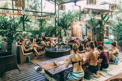 a group of people sitting in a room with plants at Danyasa Eco-Retreat in Dominical
