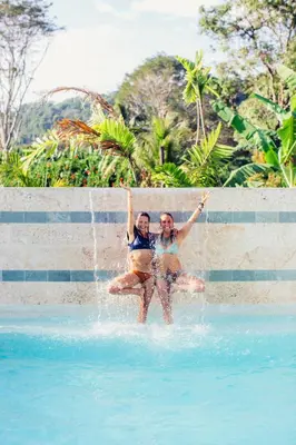 two people are in a pool in the water at Danyasa Eco-Retreat in Dominical