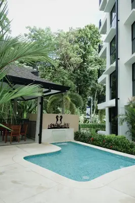 a swimming pool in front of a building at Luxury Suite Torres Del Mar Jacó in Jacó