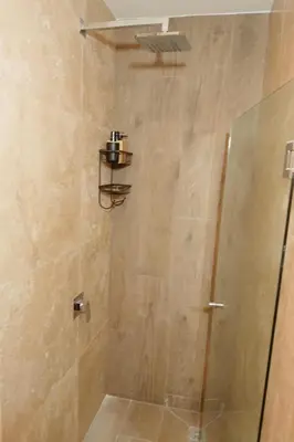 a shower with a glass door in a bathroom at Luxury Suite Torres Del Mar Jacó in Jacó
