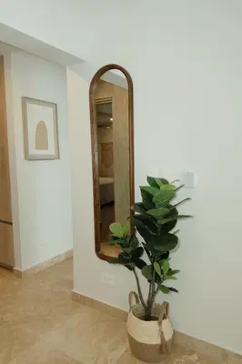 a bathroom with a mirror and a potted plant at Luxury Suite Torres Del Mar Jacó in Jacó