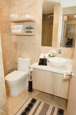 a bathroom with a toilet and a sink at Luxury Suite Torres Del Mar Jacó in Jacó