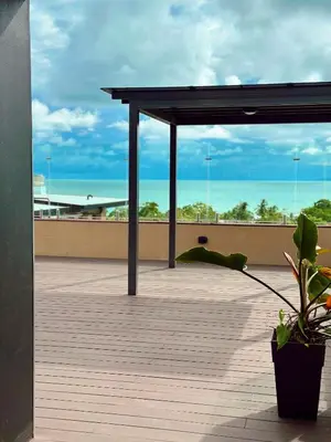 a person laying on the roof of a building at Luxury Suite Torres Del Mar Jacó in Jacó