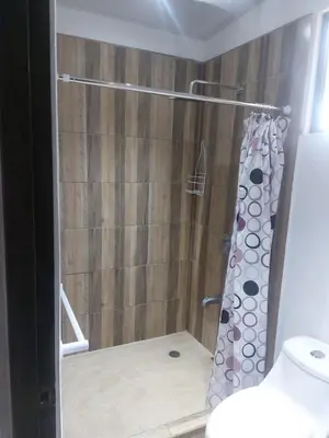 a shower with a shower curtain in a bathroom at Casa playa 2 in Huacas