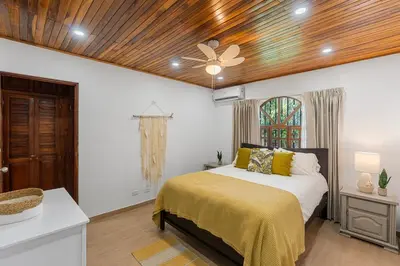 a bedroom with a bed and a ceiling fan at VBM6 Delightful Beachside Cottage Close to Beach in Tamarindo