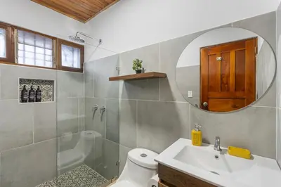 a bathroom with a sink and a shower and a toilet at VBM6 Delightful Beachside Cottage Close to Beach in Tamarindo