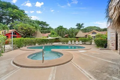 a swimming pool in the middle of a yard at VBM6 Delightful Beachside Cottage Close to Beach in Tamarindo
