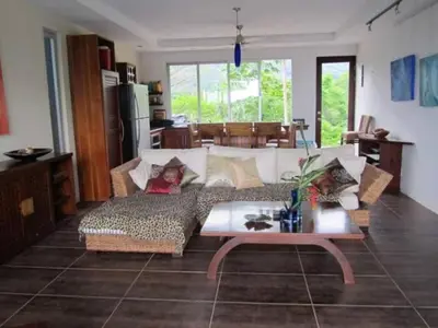 a living room with a couch and a table at Casa Candelitas Private Yoga ocean view house in Nicoya