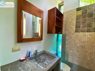 a bathroom with a sink and a mirror at Casa Candelitas Private Yoga ocean view house in Nicoya