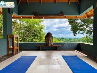 a statue of a head sitting on a table in a room at Casa Candelitas Private Yoga ocean view house in Nicoya