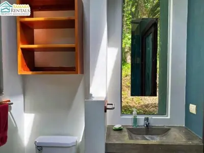 a bathroom with a sink and a mirror at Casa Candelitas Private Yoga ocean view house in Nicoya