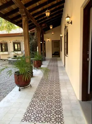 a hallway of a house with potted plants on it at Casa Caoba Playa Potrero in Playa Flamingo