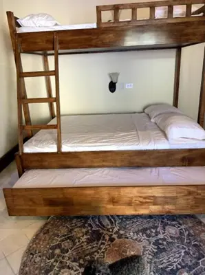 two bunk beds in a room with a rug at Casa Caoba Playa Potrero in Playa Flamingo
