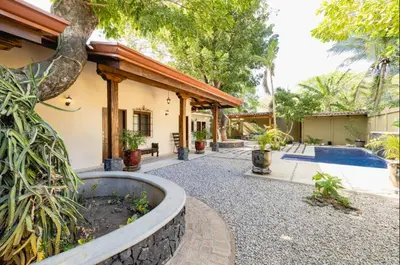a courtyard of a house with a swimming pool at Casa Caoba Playa Potrero in Playa Flamingo